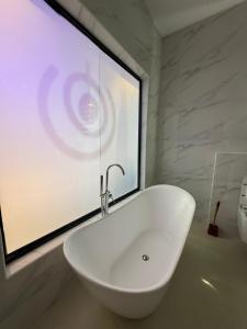 a white sink in a bathroom with a window at Danjo Shortlets in Aja +7 photos