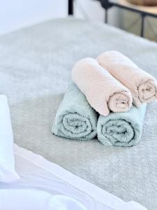 a pile of towels sitting on top of a bed at Lefteris Traditional Rooms in Fira +69 photos