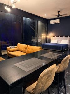 a living room with a bed and a table and chairs at Deluxe loft with direct access to the lagoon in Momoxpan