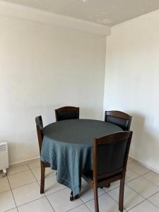 a dining room table with chairs and a blue table cloth at Edificio león Gallo in Temuco +4 photos