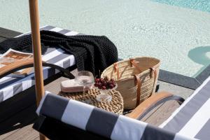 a table with a glass of wine next to a swimming pool at Domki w Białce WOODHOUSE- Twój górski azyl przy stoku in Białka Tatrzańska
