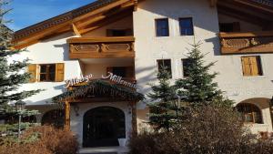 a building with a sign on the front of it at Millenniumhotel in Vigo di Fassa