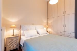 a bedroom with a large bed with white cabinets at Iliodysi Houses in Methoni