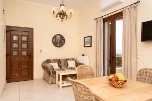 a living room with a table and a couch at Iliodysi Houses in Methoni