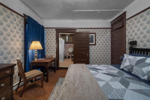 a bedroom with a bed and a desk and a chair at McCleary Hotel in McCleary +64 photos