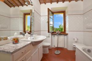 a bathroom with a sink and a toilet and a tub at Casa Sofi - Happy Rentals in Monticiano +36 photos