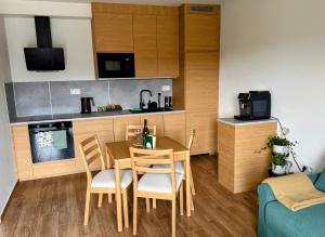 a small kitchen and dining room with a table and chairs at Pobyt na Mlýně in Červená Voda