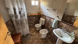 a bathroom with a toilet and a bidet and a sink at Casa El Roble in San Rafael +44 photos