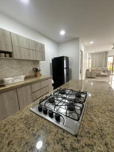a kitchen with a stove top oven sitting on a counter at Apartamento completo cerca del centro in Montería