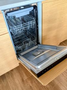 a dishwasher with its door open in a kitchen at Pobyt na Mlýně in Červená Voda