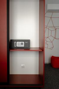 a microwave sitting on a shelf in a room at Arkadia Beach Hotel in Odesa