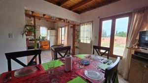 a dining room with a table with a green table cloth at La Colina in Río Mayo
