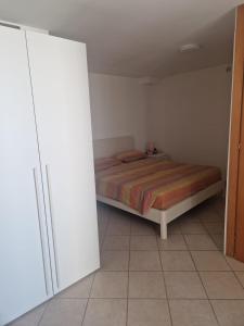 a small bedroom with a bed and a closet at Caty House in Nettuno
