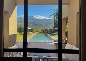 a view of a swimming pool through a window at Villa A Atlas Retreat Luxury B and B Beni Mellal in Beni Mellal +68 photos