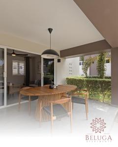 a dining room with a wooden table and chairs at Beluga Apartments Curacao - nabij Willemstad & Mambo Beach in Willemstad