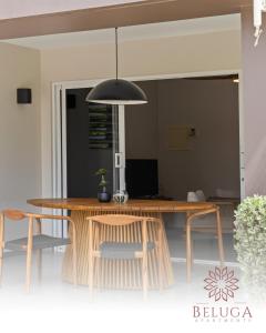 a dining room with a wooden table and chairs at Beluga Apartments Curacao - nabij Willemstad & Mambo Beach in Willemstad