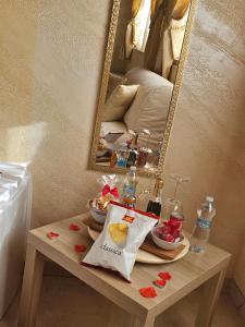 a table with a plate of food and a mirror at Golden house sicily in Catania