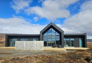 a modern house with a black roof at Aurora luxury villa in Reykholt