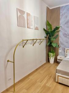 a room with a bed and a plant on a wall at Onny's Palace in Bari