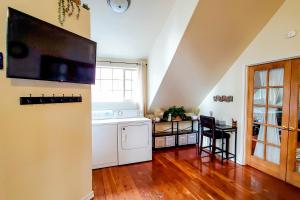 a kitchen with a dishwasher and a tv on the wall at Explore Caves & Coast! Family-Friendly Oregon Stay in Cave Junction