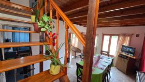 a living room with a staircase in a house at La Colina in Río Mayo