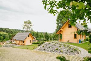 a house with a lot of rocks in front of it at PUŹNIAKÓWKA in Czarna