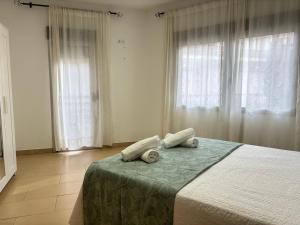 a bedroom with a bed with two pillows on it at Desconectaengalicia Carlos Casas Playa Silgar in Sanxenxo +13 photos
