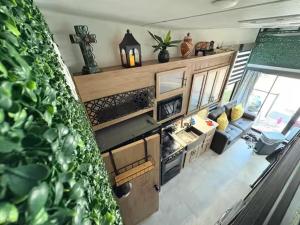 an aerial view of a kitchen and living room in an rv at Bumblebee - Luxury Destination Trailer in Canyon Lake