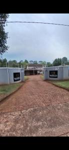 a brick parking lot with a building in the background at Maselli Guesthouse in Howick