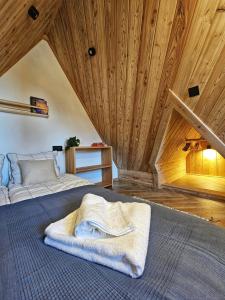 a bedroom with a bed with a blanket on it at Apartament Rysulówka 76 in Kościelisko
