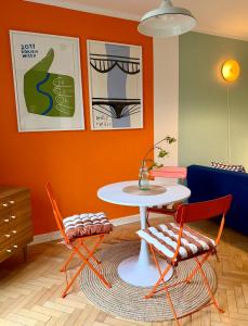 a dining room with a table and two chairs at Lovely Jubbly Apartment in Krakow +17 photos