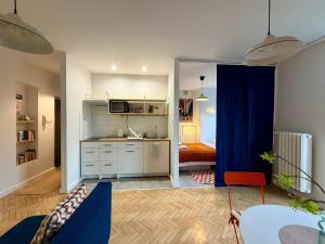 a kitchen with a blue curtain in a room at Lovely Jubbly Apartment in Krakow