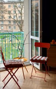 two chairs and a table in front of a window at Lovely Jubbly Apartment in Krakow