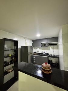 a kitchen with a black counter top in a room at Do mar ao Lar in Rio de Janeiro