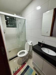 a bathroom with a shower and a toilet and a sink at Do mar ao Lar in Rio de Janeiro