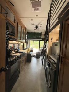 a kitchen and living room of an rv at Bumblebee - Luxury Destination Trailer in Canyon Lake