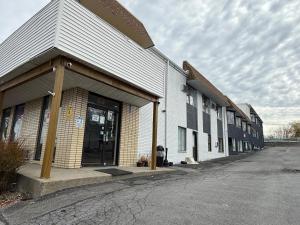 a building with a door on the side of a street at Monte Mario Motel & Efficiency in Latham +4 photos