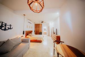 a living room with a bed and a couch at Villa Marena Hotel Boutique in Coyuca +42 photos
