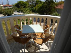 a table and chairs sitting on a balcony at Hotel Villa Basil in Tsilivi