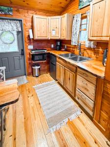 a kitchen with a sink and a stove at Treehouse by the Creek in Walland