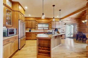 a large kitchen with wooden cabinets and a counter top at The Dockside Gamehouse in Olympia