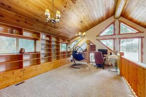 a large room with wooden ceilings and a large window at The Dockside Gamehouse in Olympia