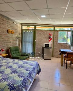 a bedroom with a bed and a table and chairs at Costa Azul 2 in Villa Pehuenia +2 photos