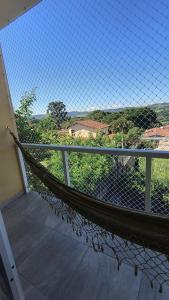 a hammock on the balcony of a house at Refúgio perfeito em Itatiba in Itatiba