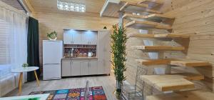 a kitchen with a spiral staircase in a wooden house at Arista Yurt Camp in Karakol