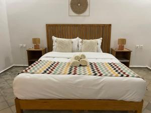 a bedroom with a bed with two towels on it at La Perle d'Argan in Essaouira +80 photos