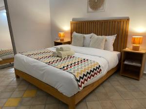 a bedroom with a bed with a teddy bear on it at La Perle d'Argan in Essaouira