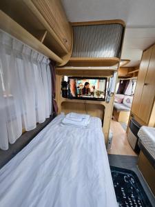 a bed in the back of a camper van at Radbjerg privat camping in Væggerløse