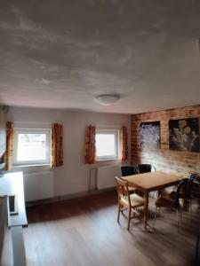 a dining room with a table and chairs at Chata Florian in Adolfov +21 photos