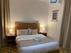 a bedroom with a bed with two teddy bears on it at La Perle d'Argan in Essaouira